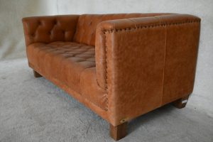 Gebruikte moderne chesterfield bank met geknoopte zitting in cognac kleur